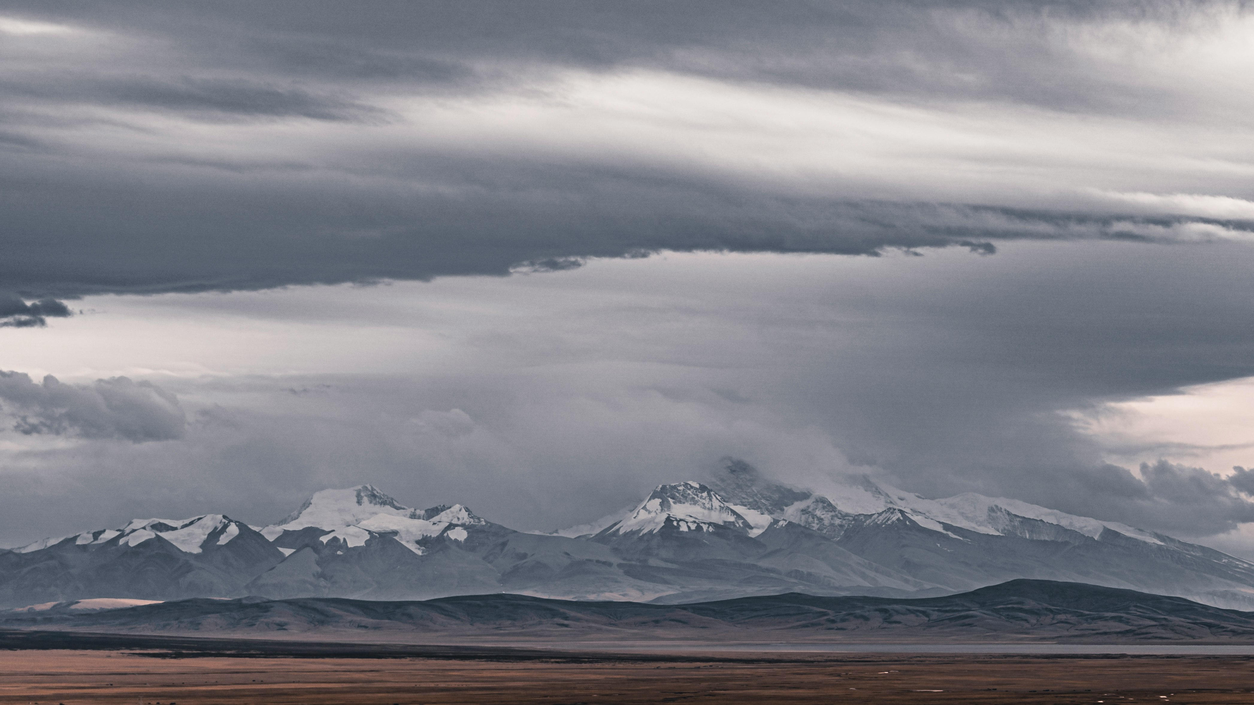 snow covered mountain under cloudy sky during daytime